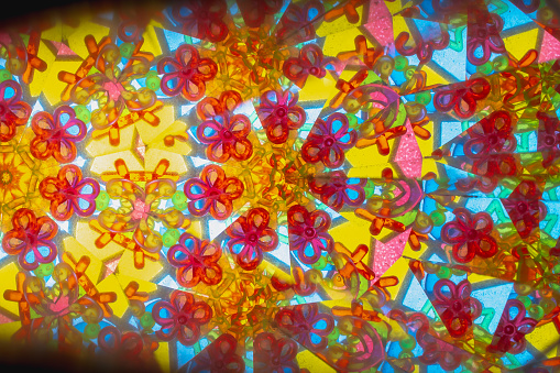 A pattern of colored glass in a kaleidoscope.