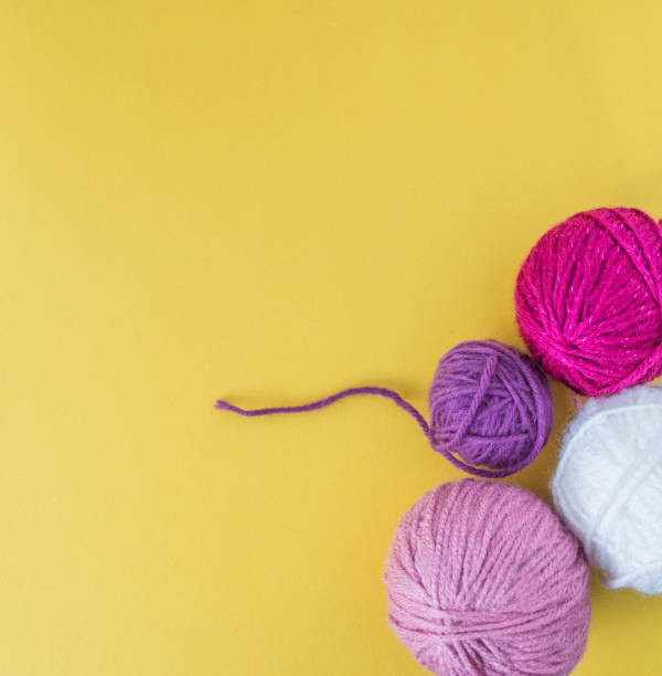 istock colorful woolen balls on yellow ground 1362084579