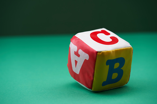soft toy ,colorful abc cubes on the green background