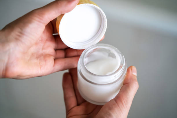 istock Girl holds a jar with a cream in her hands. 1362088112