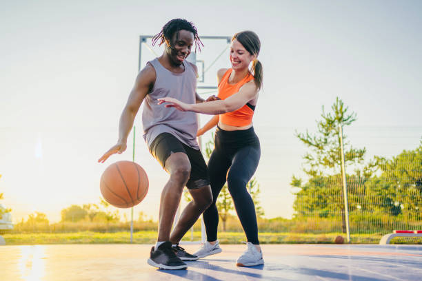istock Couple enjoying basketball match 1362089318