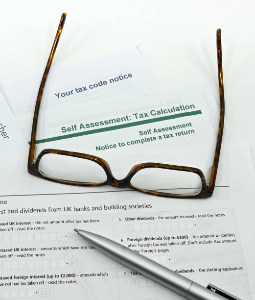 istock Tax forms with pen and a pair of glasses 1362090424