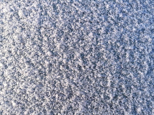 istock Snow and ice on car window cold winter day 1362091461