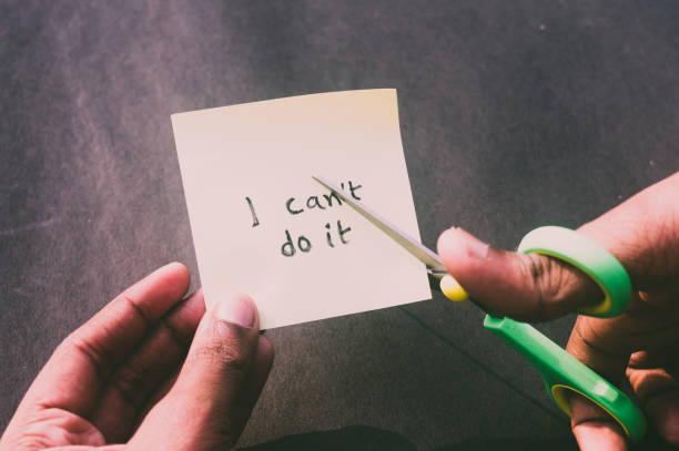 istock Hands cutting letter T with scissors with written text i can't do it. Business concept for determination Success Challenge self believe Motivation and aspirations to achieve results Aim goal. 1362093019