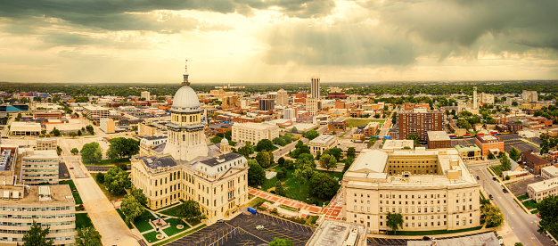Aerial panorama of the Illinois State Capitol dome and Springfield skyline under a dramatic sunset. Springfield is the capital of the U.S. state of Illinois and the county seat of Sangamon County