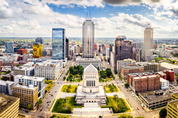 Indiana Statehouse and Indianapolis skyline on a sunny afternoon. Aerial view of Indianapolis, Indiana skyline above Indiana World War Memorial and University park, and along Meridian and Pennsylvania streets. indiana photos stock pictures, royalty-free photos & images