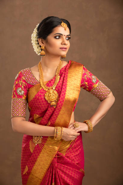 istock Beautiful smiling Indian bride with jewelry in studio shot. 1362095611