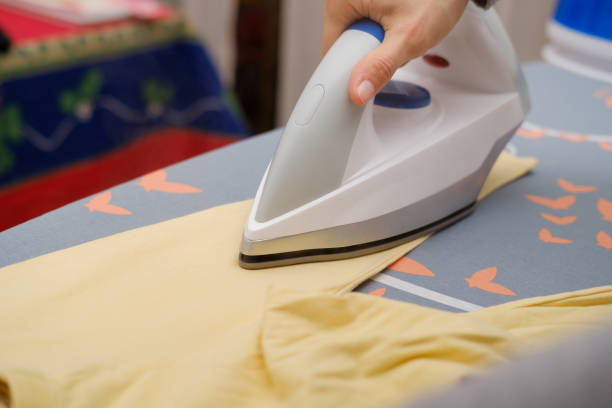 istock Mother ironing her daughter's clothes at home 1362107120