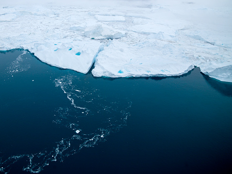 aerial view of glaciers floating on arctic ocean