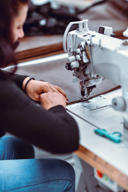 istock Side View Of Focused Female Textile Worker Sewing Cloth At Work 1362118155