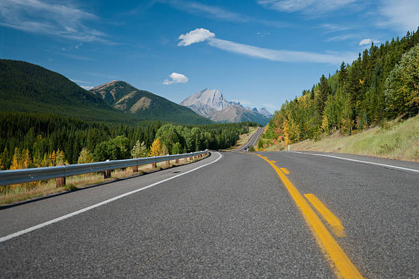 Beautiful landscape with road through  Rocky mountains stock photo