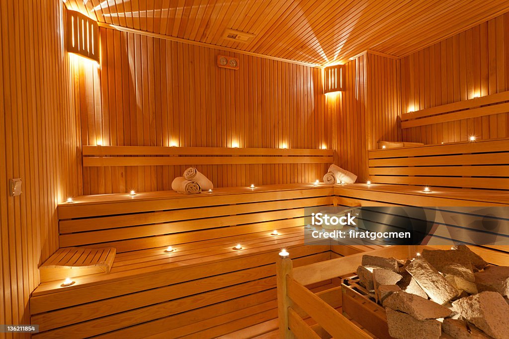 sauna brand new sauna with white towels, wooden bucket and stones Sauna Stock Photo