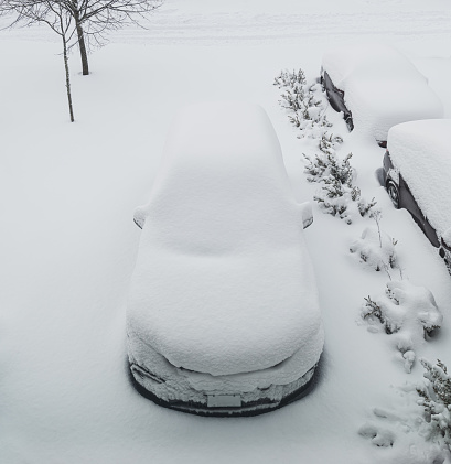 A vehicle covered in deep snow.