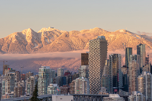 Vancouver, Canada - Circa 2021 : Downtown Vancouver with snowy mountain background