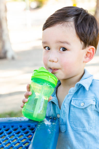 istock Chinese and Caucasian Boy Drinking Water At Playground. 1362129168
