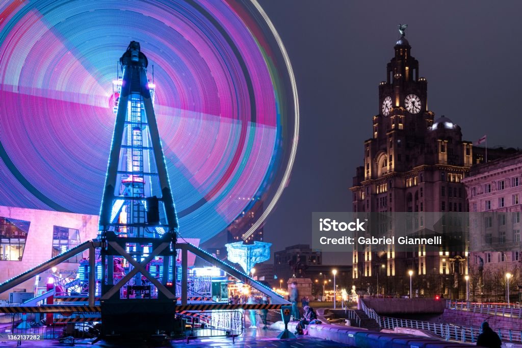 Pier Head Ice Festival Long Exposure of fun fair ride in front of the Liver Building during the Pier Head Ice Festival Liverpool - England Stock Photo