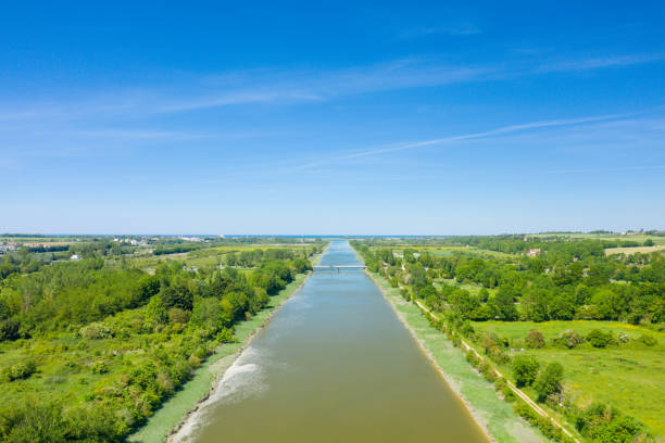The Pont de Ranville on the Canal de l'Orne in the middle of the countryside in Europe, in France, in Normandy, towards Caen, in Ranville, in summer, on a sunny day. stock photo