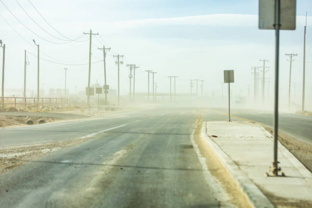 A sand storm blows across the highway near the community of Orla, Texas which is located in the extremely profitable Permian Basin. A sand storm blows across the highway near the community of Orla, Texas which is located in the extremely profitable Permian Basin. carlsbad texas stock pictures, royalty-free photos & images