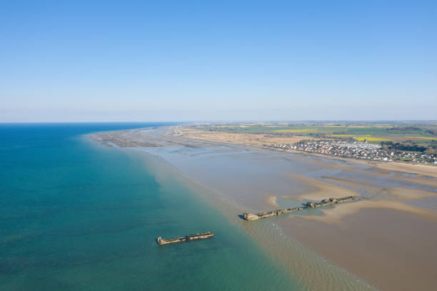 The panoramic view of the artificial port of Gold beach in Asnelles in Europe, in France, in Normandy, in Arromanches les bains, in summer, on a sunny day. stock photo