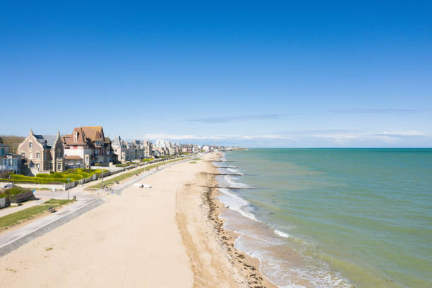 The long beach of the Overlord landing of fine sand of Sword beach in Lion-sur-Mer in Europe, in France, in Normandy, towards Ouistreham, in summer, on a sunny day. stock photo