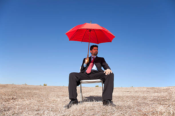 istock Businessman with a red umbrella 136215078