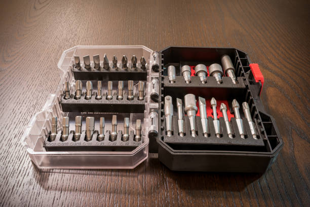 istock A plastic container with drill bits and other accessories on a dark wooden table with light shining from one side.  Shot with focus stacking to have the bits in focus from front to rear. 1362155414