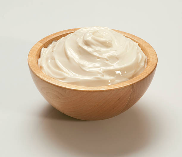 Whipped cream in light wooden bowl on white backing cream cheese in a wooden bowl cream cheese stock pictures, royalty-free photos & images