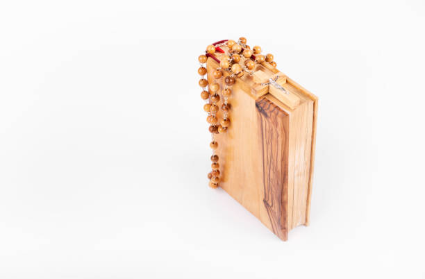 istock Bible with wooden cross isolated on white background. 1362164606