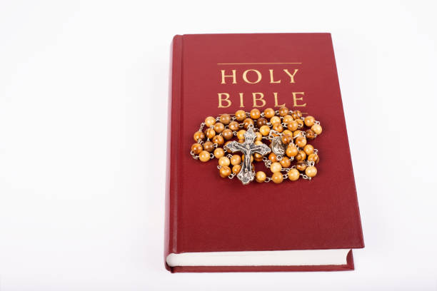 istock Bible with wooden rosary isolated on white background. 1362164614