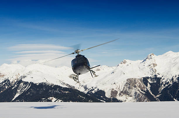 istock A mountain rescue helicopter in flight by snowy mountains 136216575