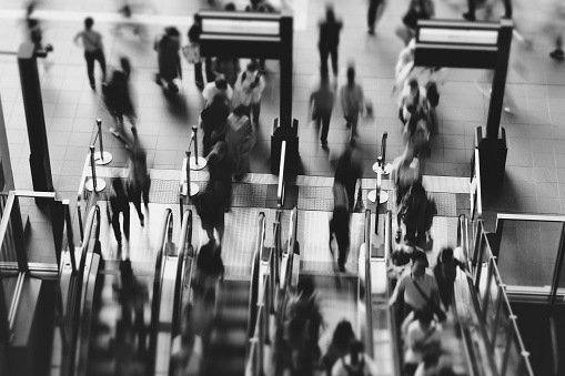 Photo of a person riding an escalator