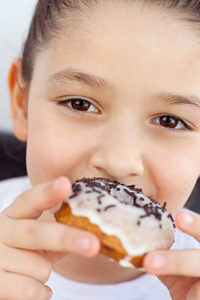 istock Cute Girl eating donut 136217165