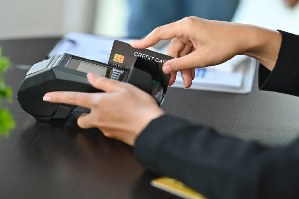 istock Cropped image of customer's hand doing payment by using a credit card at the credit card reader. 1362176448
