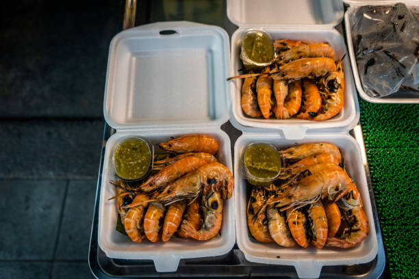 Fresh grilled shrimp for sale at an outdoor market in Bangkok, Thailand