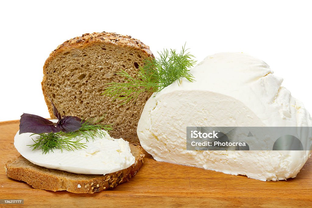 whole wheat bread, cottage cheese and healthy sandwich whole wheat bread, cottage cheese and healthy sandwich on a cutting board isolated on white Bakery Stock Photo