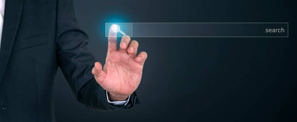 istock Businessman finger clicking on internet search button on screen. touching screen. Searching browsing internet information concept. 1362178191