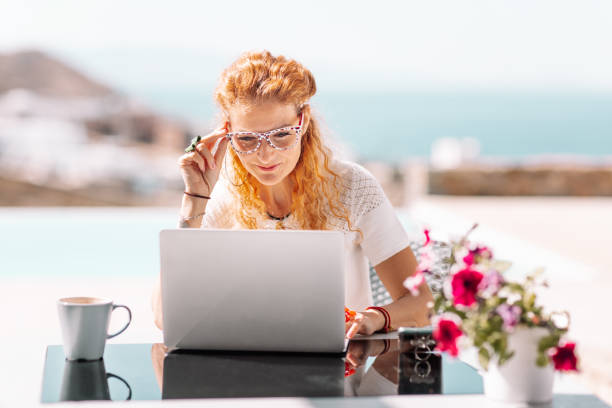 istock Business woman using laptop on terrace 1362180753