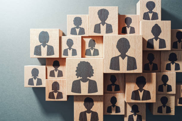 Team work and human resource management concept. Top view of various wood cubes with people icons. Personnel stock pictures, royalty-free photos & images