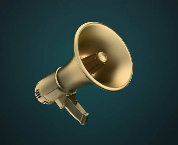 Photo of golden megaphone on a dark background