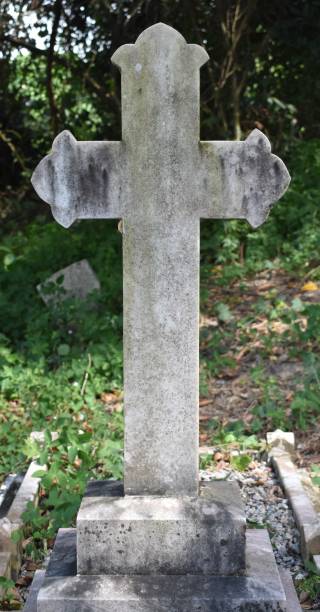 istock Traditional stone cross in a rural cemetery 1362187019
