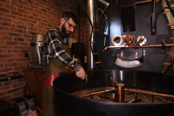 istock Worker checking quality of roasted coffee beans 1362189440