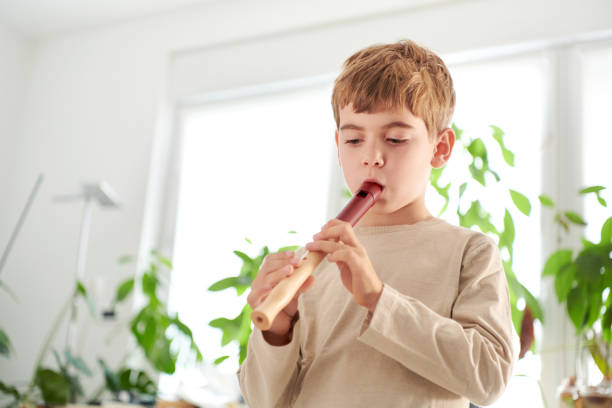 istock Portrait of a Child Practicing and Learning Flute at Home 1362191050