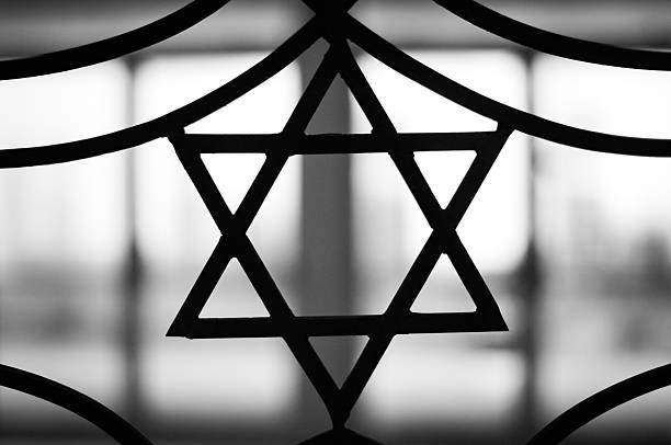 The Star of David signifying Jewish religion Iron casted Star in black and White with a dramatic back light overtone. The Star of David, known in Hebrew as the Shield of David or Magen David, is the quintessential symbol of Jewish identity. rabbi photos stock pictures, royalty-free photos & images