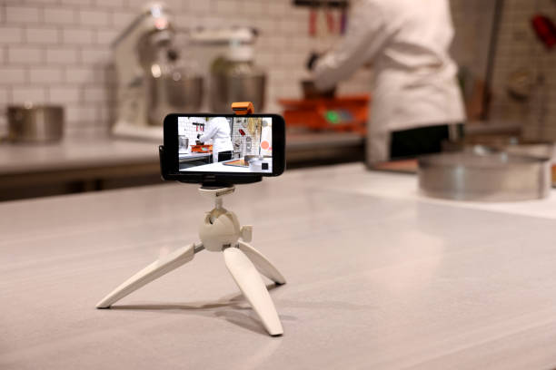 istock A woman chef is recording her own video on her mobile phone while cooking. 1362196807