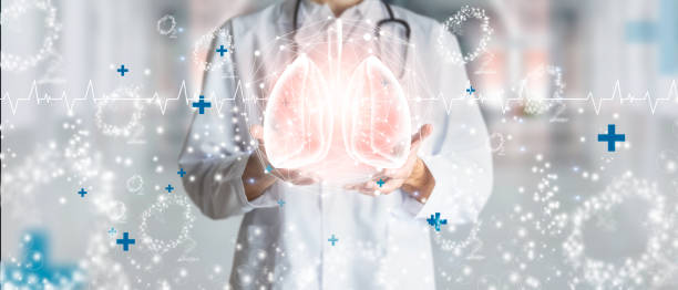 Doctor holding hologram of human lungs surrounded by oxygen as a concept of respiratory health. stock photo