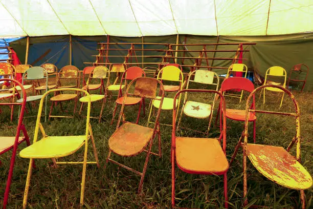 Photo of Audience of traveling circus with empty chairs