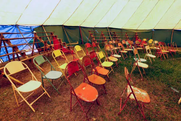 Photo of Audience of traveling circus with empty chairs