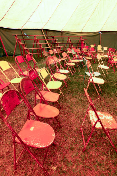 istock Audience of traveling circus with empty chairs 1362203144