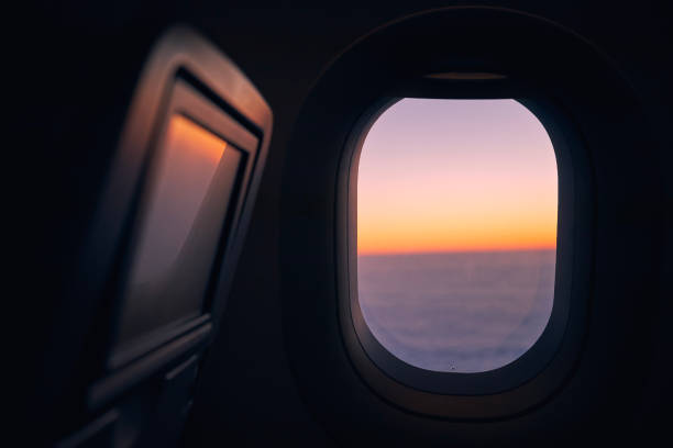 istock Window of airplane during flight at sunset 1362203355