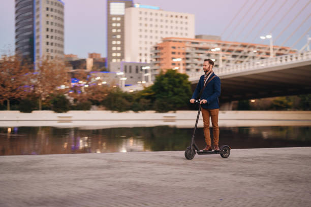 istock Businessman riding scooter at evening 1362203472